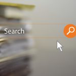 Image of a search bar with stack of books and documents in the background representing digitalisation of codes